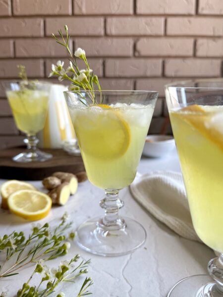 ginger turmeric lemonade in glass with ice