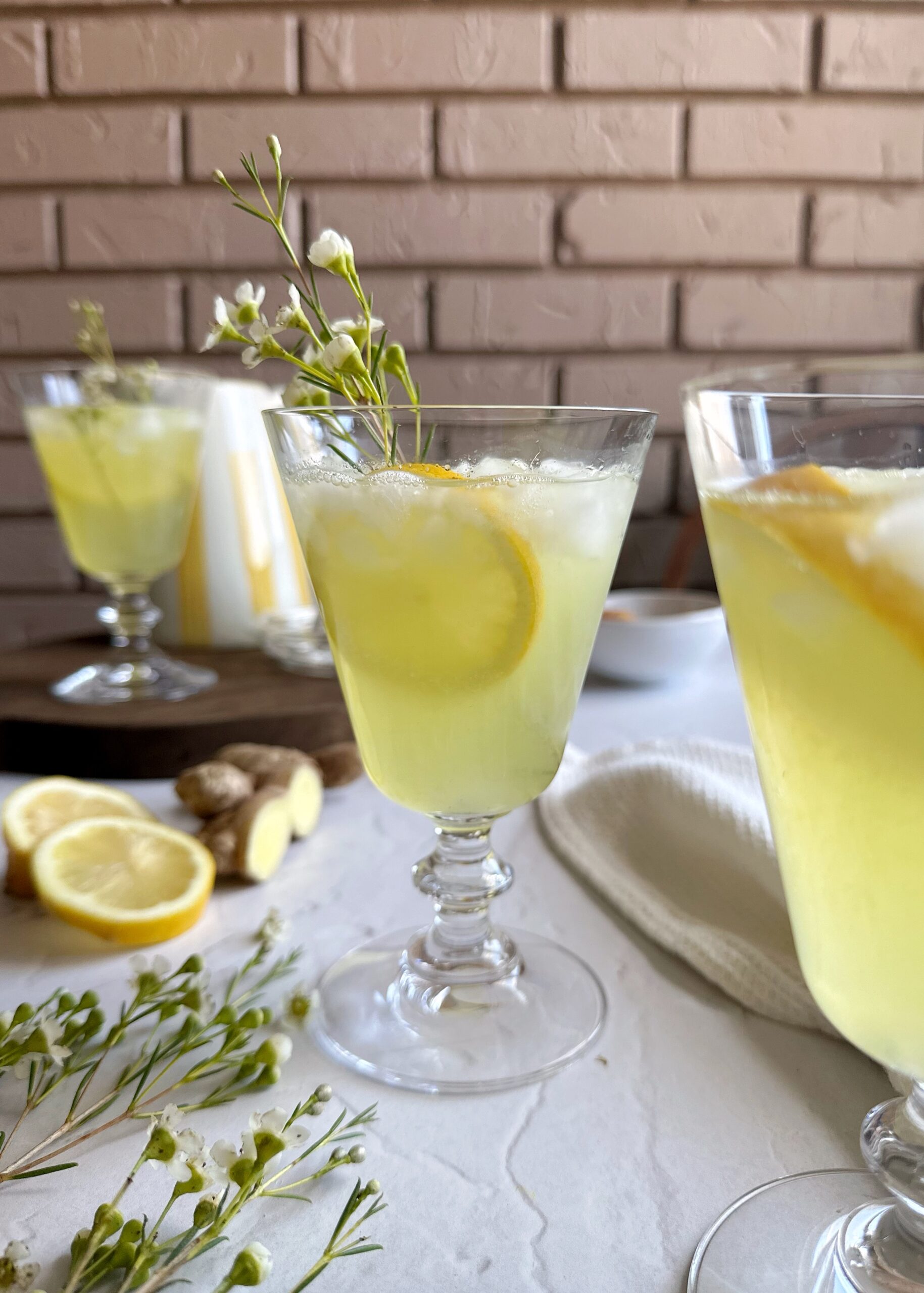 ginger turmeric lemonade in glass with ice