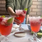 holding a raspberry mojito mocktail