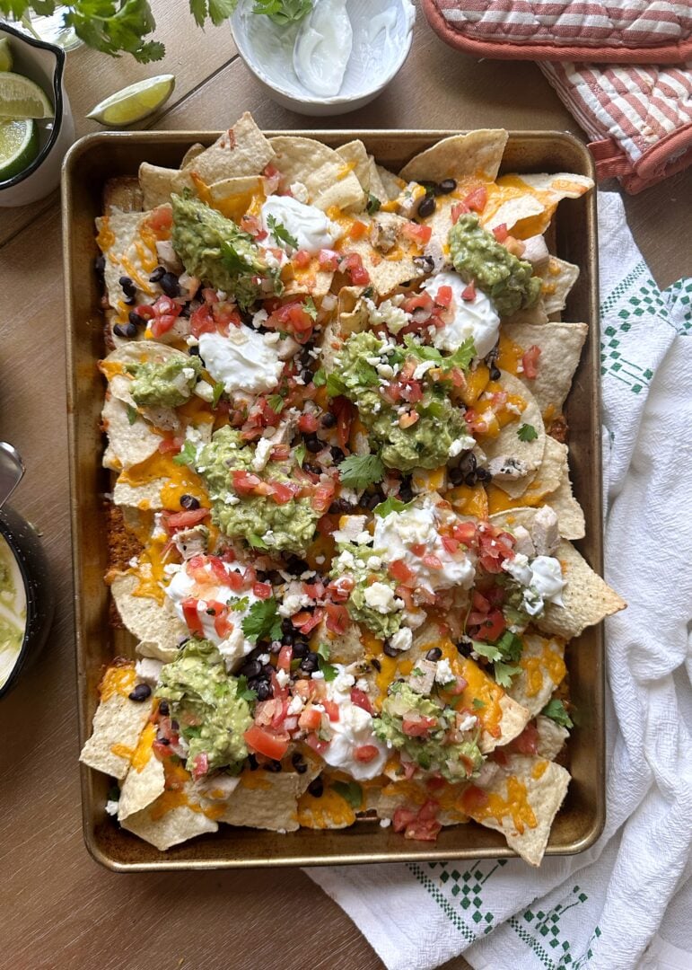 baked chicken nachos on a sheet pan