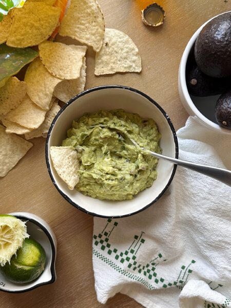 bowl of super simple guacamole with chips