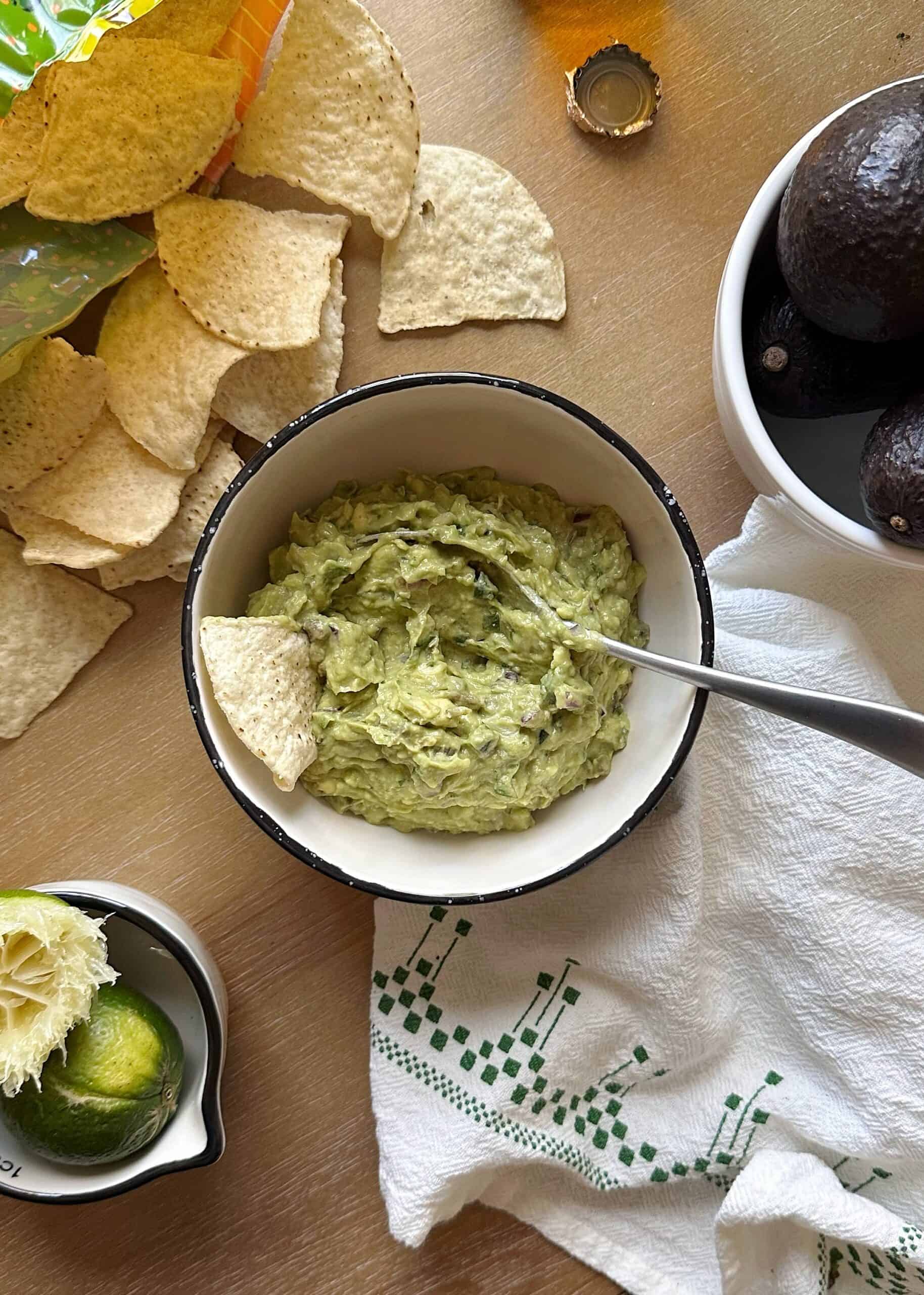bowl of super simple guacamole with chips