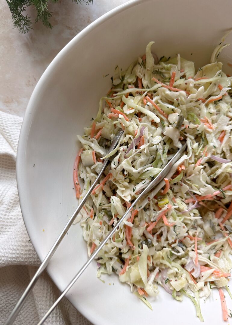 dill pickle coleslaw in white bowl