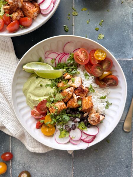 salmon burrito bowl with avocado crema