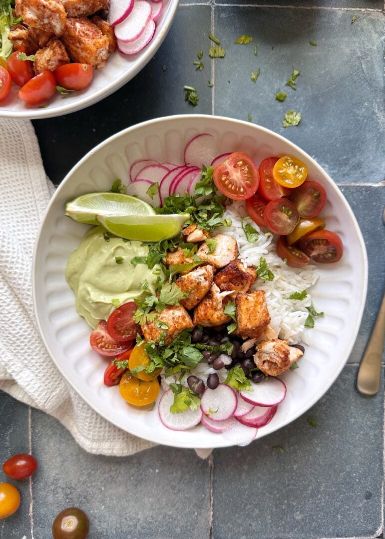 salmon burrito bowl with avocado crema