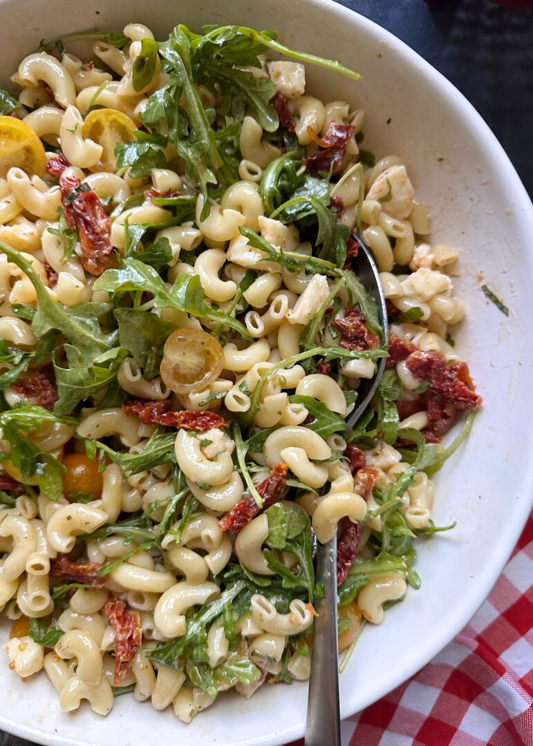 sundried tomato pasta salad in white serving bowl