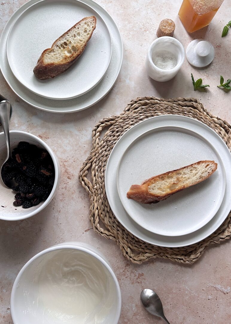 toast on white bread with ricotta and blackberries in mixing bowls