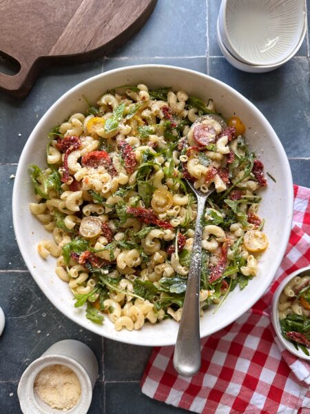 tomato lovers pasta salad with shredded parmesan cheese sprinkled on top