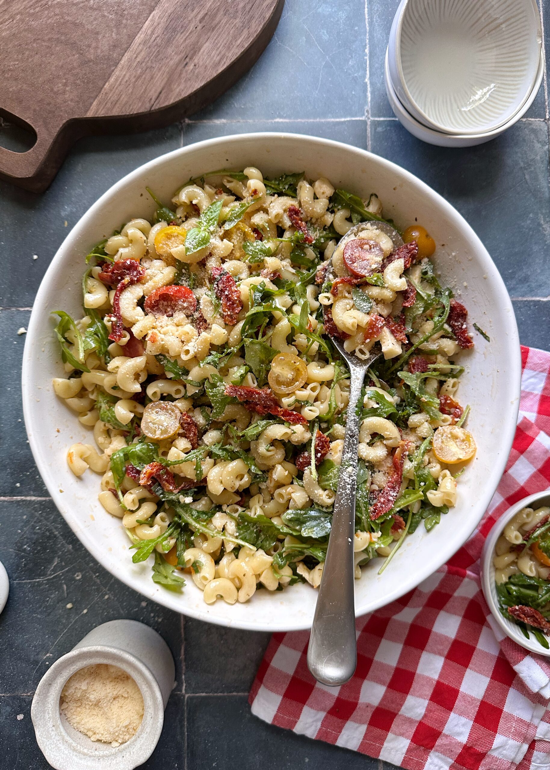 tomato lovers pasta salad with shredded parmesan cheese sprinkled on top