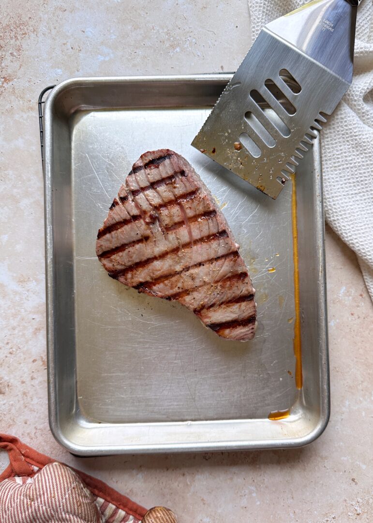 grilled tuna steak on a silver tray