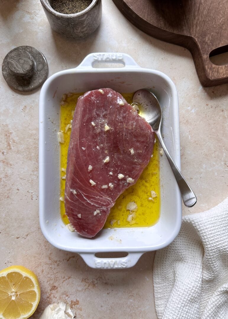 marinating tuna steak in shallow dish