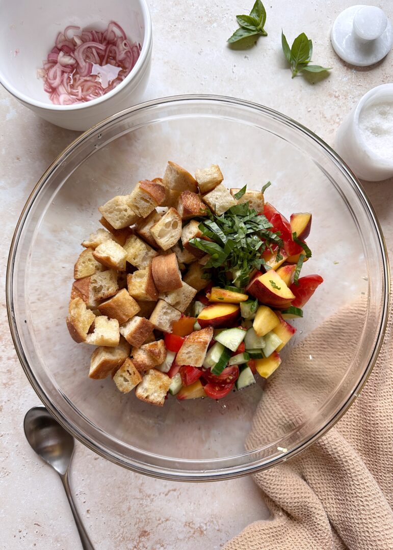 panzanella salad ingredients in a mixing bowl