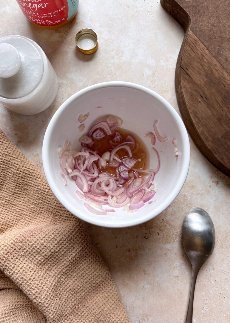 pickled shallots in a white mixing bowl