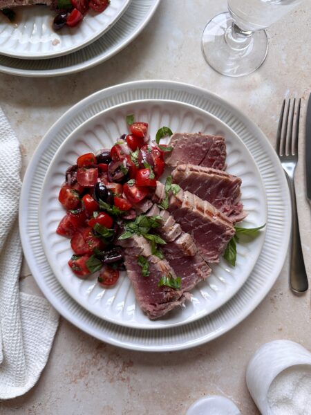 sliced grilled mediterranean tuna with tomato salad