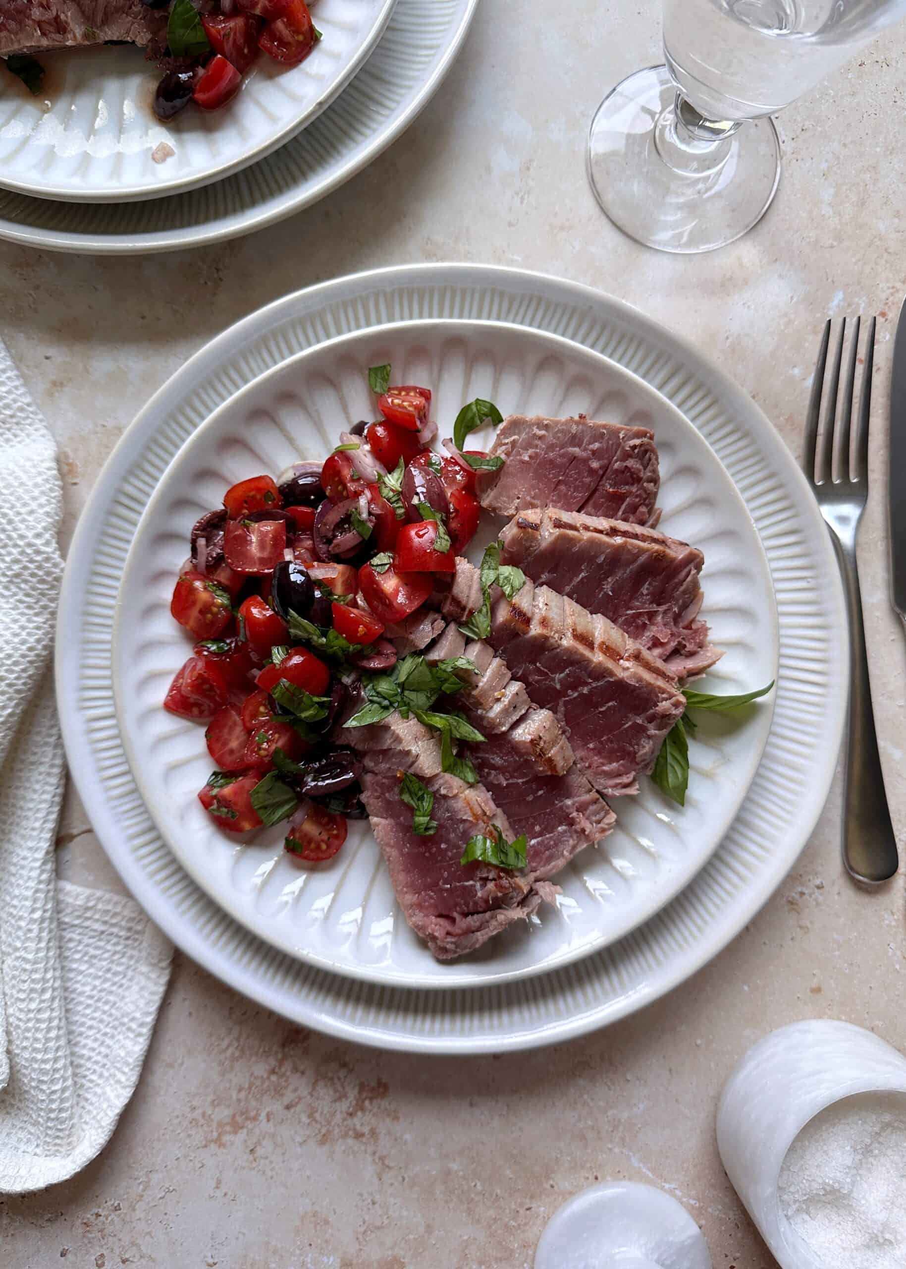 sliced grilled mediterranean tuna with tomato salad