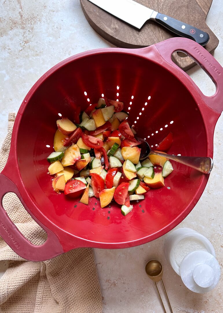 tomatoes cucumbers and peaches in a colander