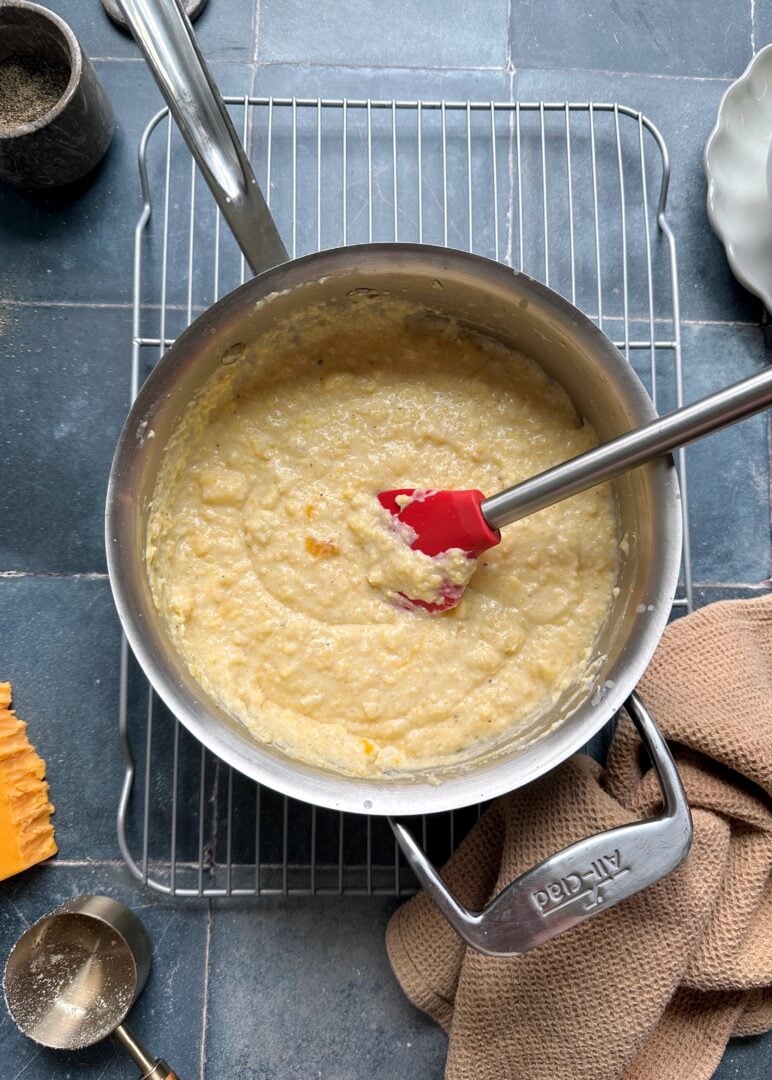 cheesy polenta in a silver saucepan