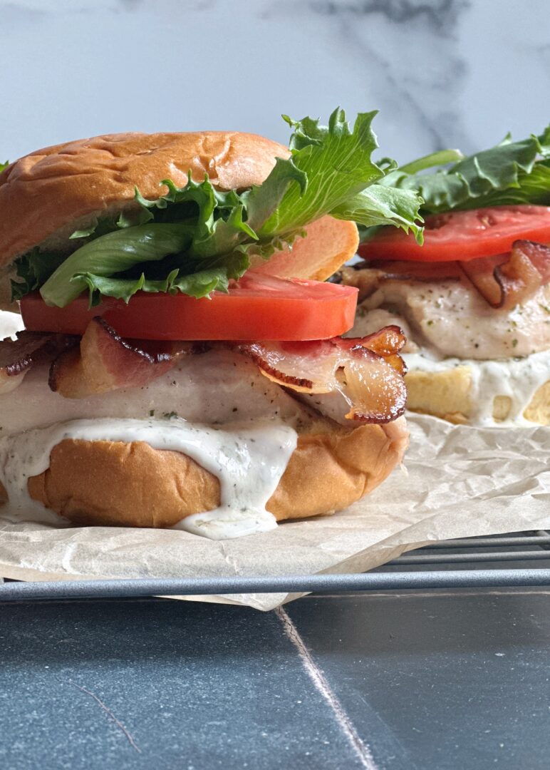 chicken ranch blt with ranch dressing dripping down the bun