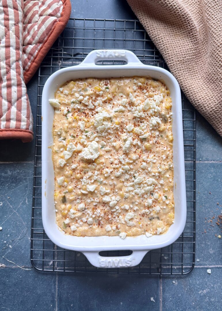 elote dip after baking with crumbled cotija and tajin on top