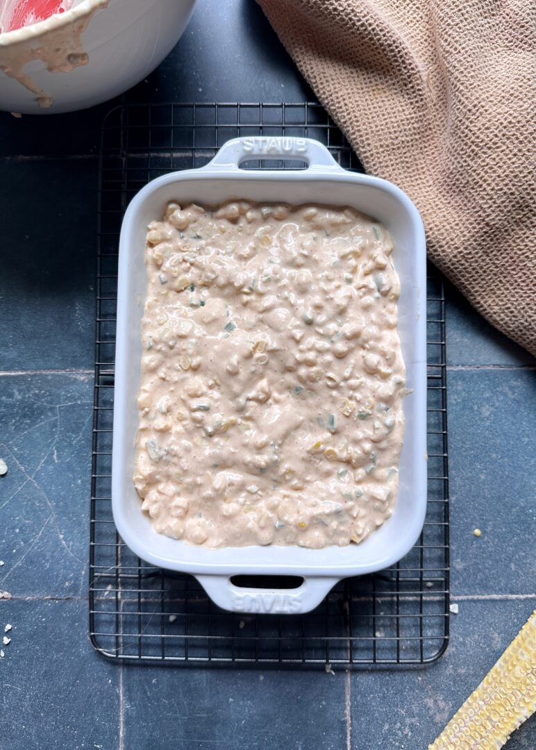 elote dip in casserole dish before baking