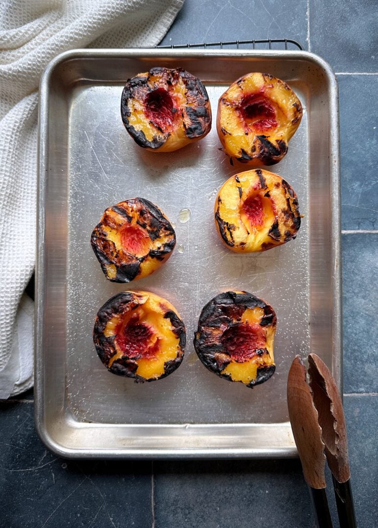 grilled peach halvse on silver tray