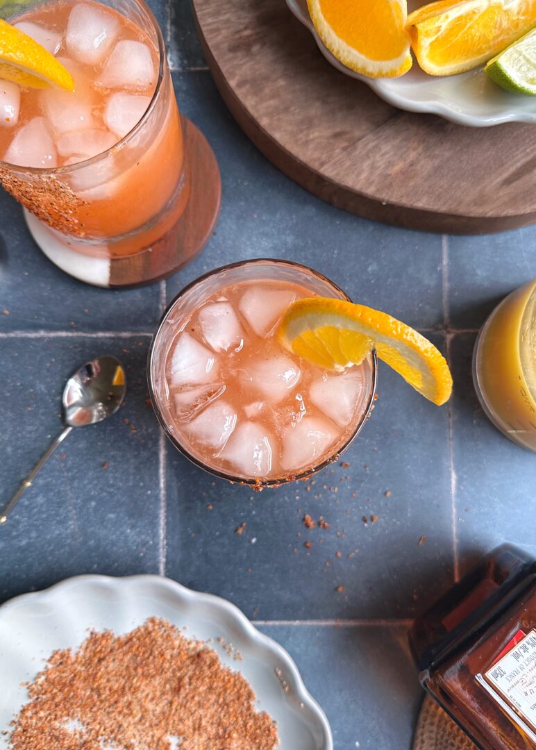 overhead photo of orange aperola margarita with orange slice