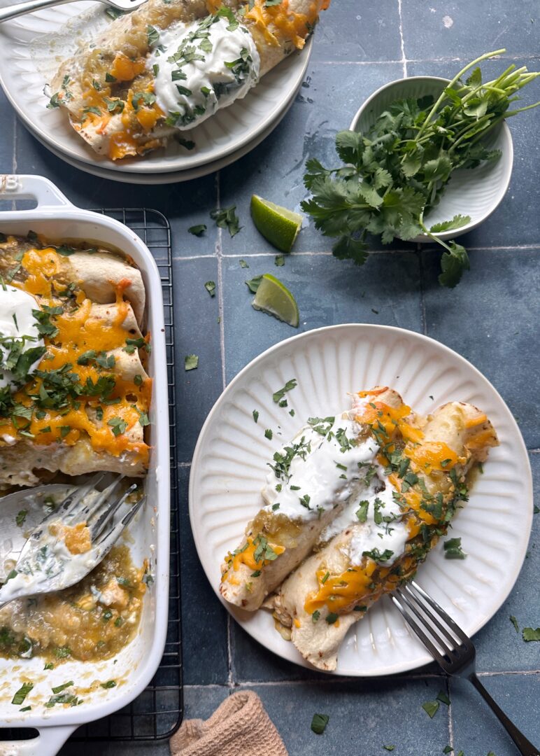 serving of green chile chicken enchiladas next on a plate