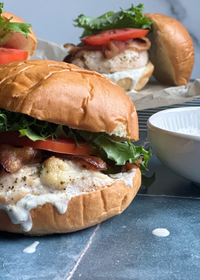 two chicken ranch blt sandwiches on brioche buns