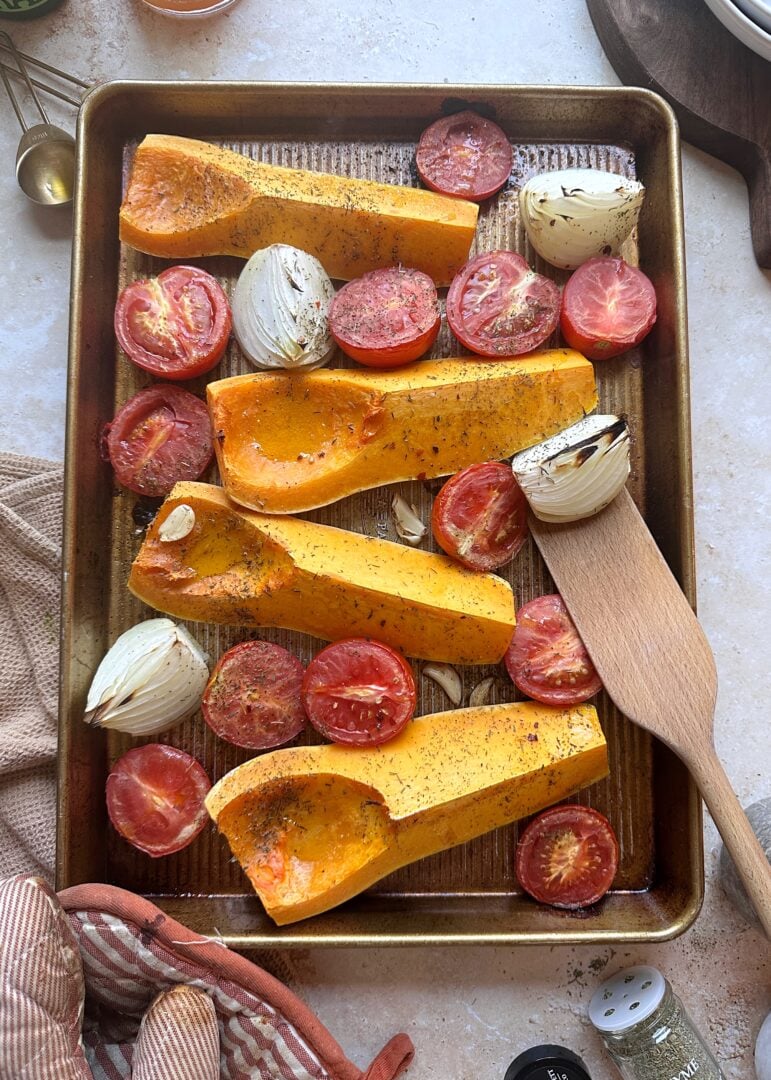 baking sheet with roasted butternut squash tomato and onion