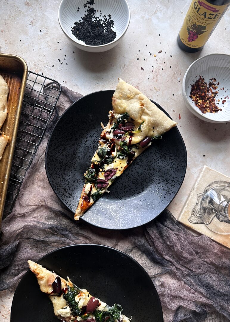 black garlic pizza with balsamic drizzle on a plate