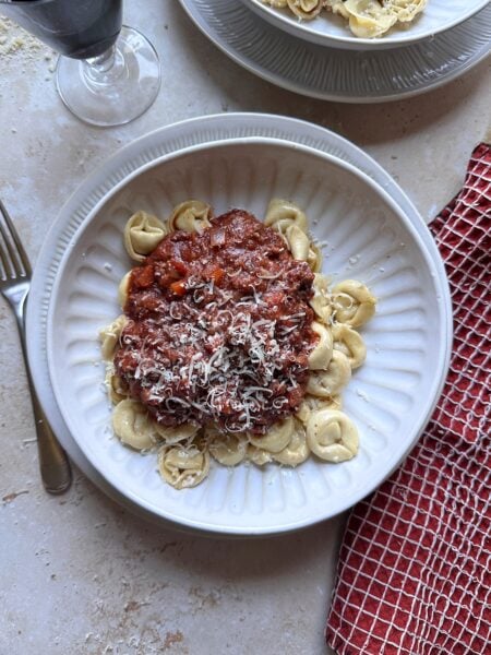 bowl of brown butter tortellini bolognese with parmesan