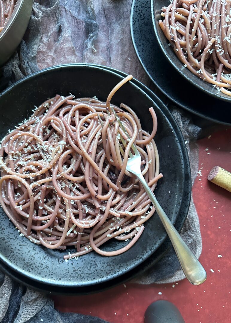 bowl of dracula's drunken pasta with a silver fork