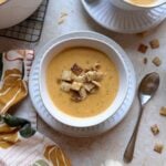 bowl of pumpkin beer cheese soup with toasted chili maple chex