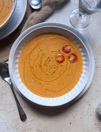 bowl of roasted tomato and butternut squash with garnish