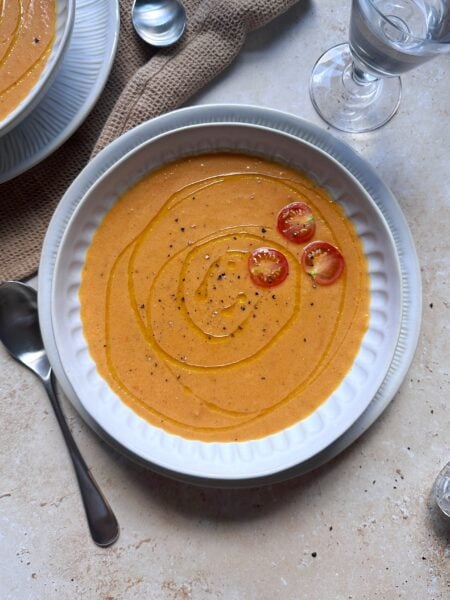 bowl of roasted tomato and butternut squash with garnish