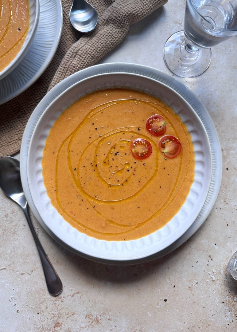 bowl of roasted tomato and butternut squash with garnish