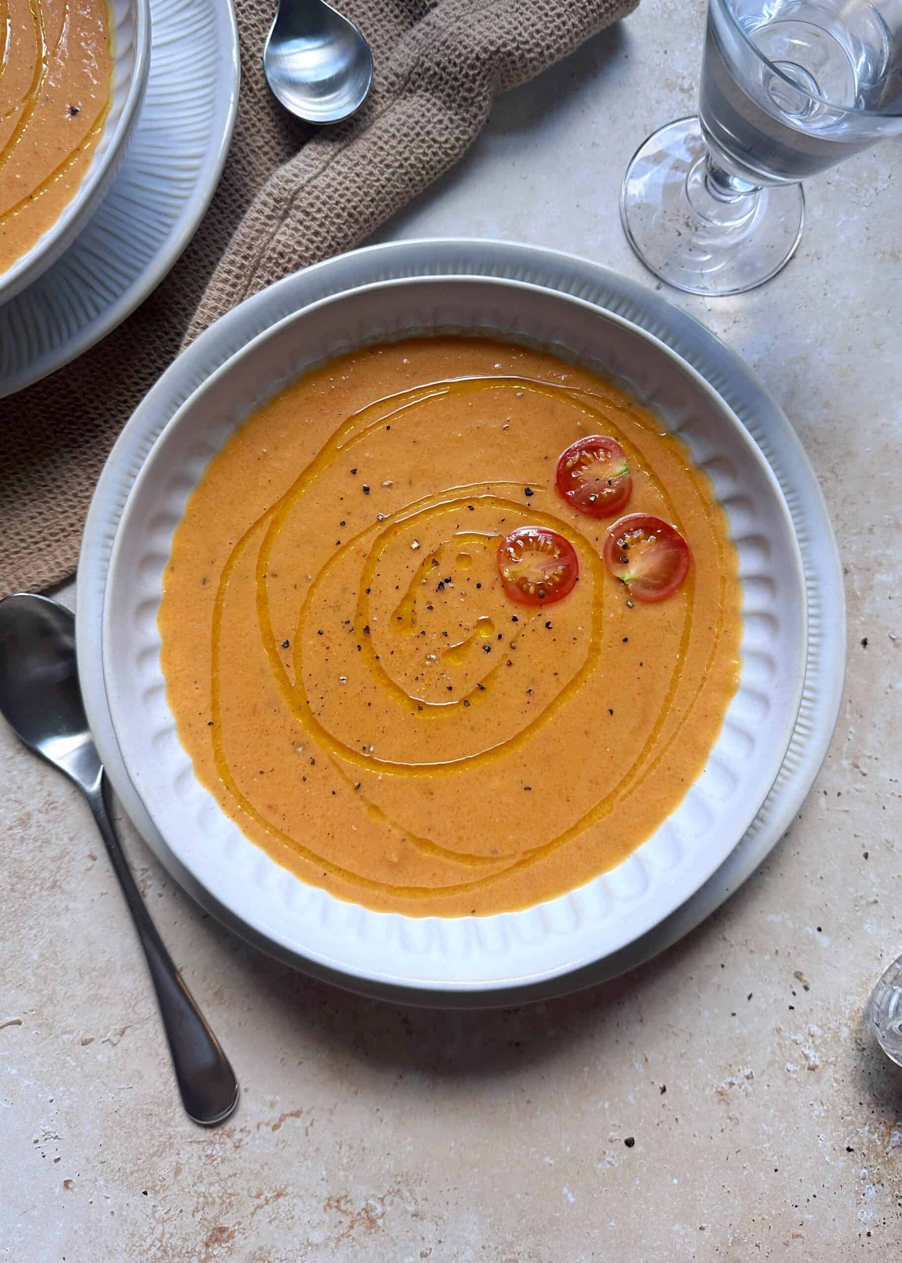 bowl of roasted tomato and butternut squash with garnish