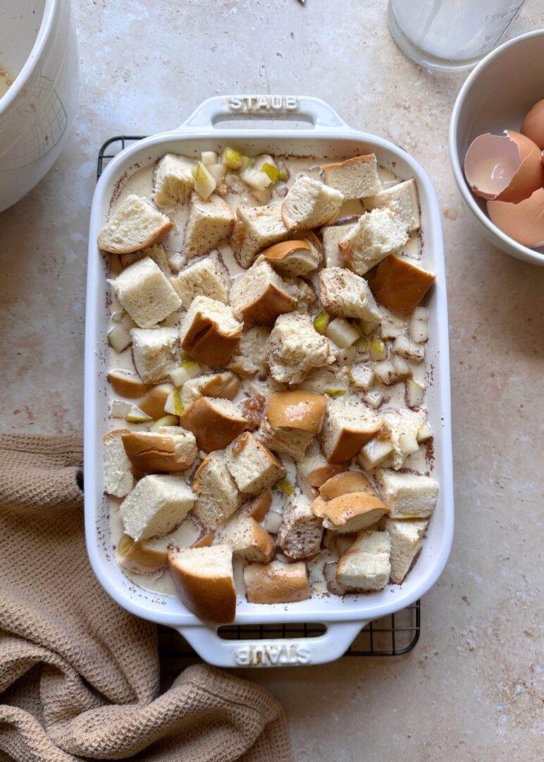 challah and pears soaking in egg and cream mixture