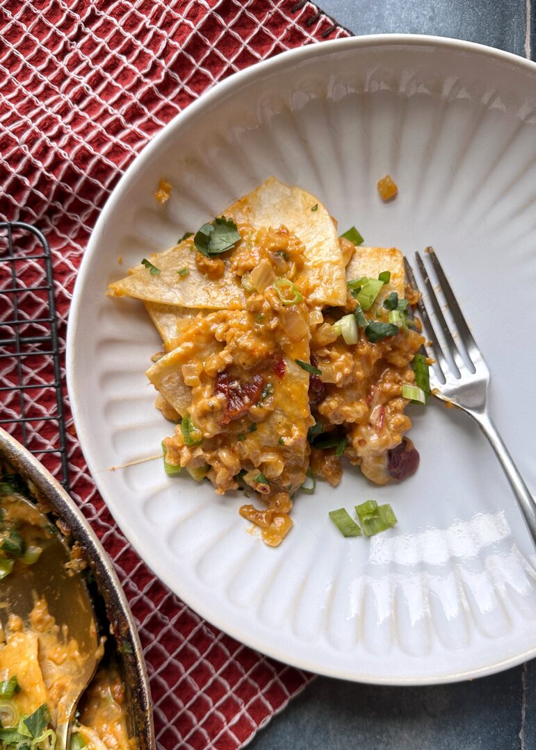 plate of chipotle pumpkin chicken enchiladas skillet
