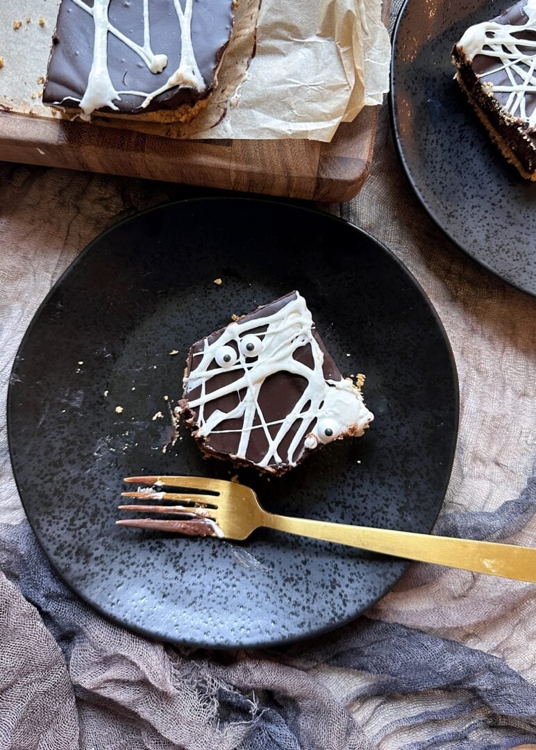 plate with a square of spiderweb smores bar with bite taken out