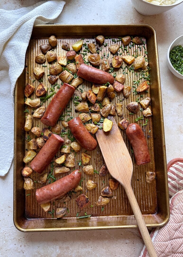 sheet pan kielbasa and potatoes with chive garnish