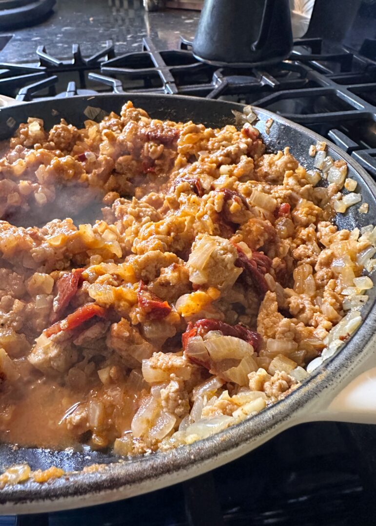 skillet of chicken chipotle and onions for enchiladas