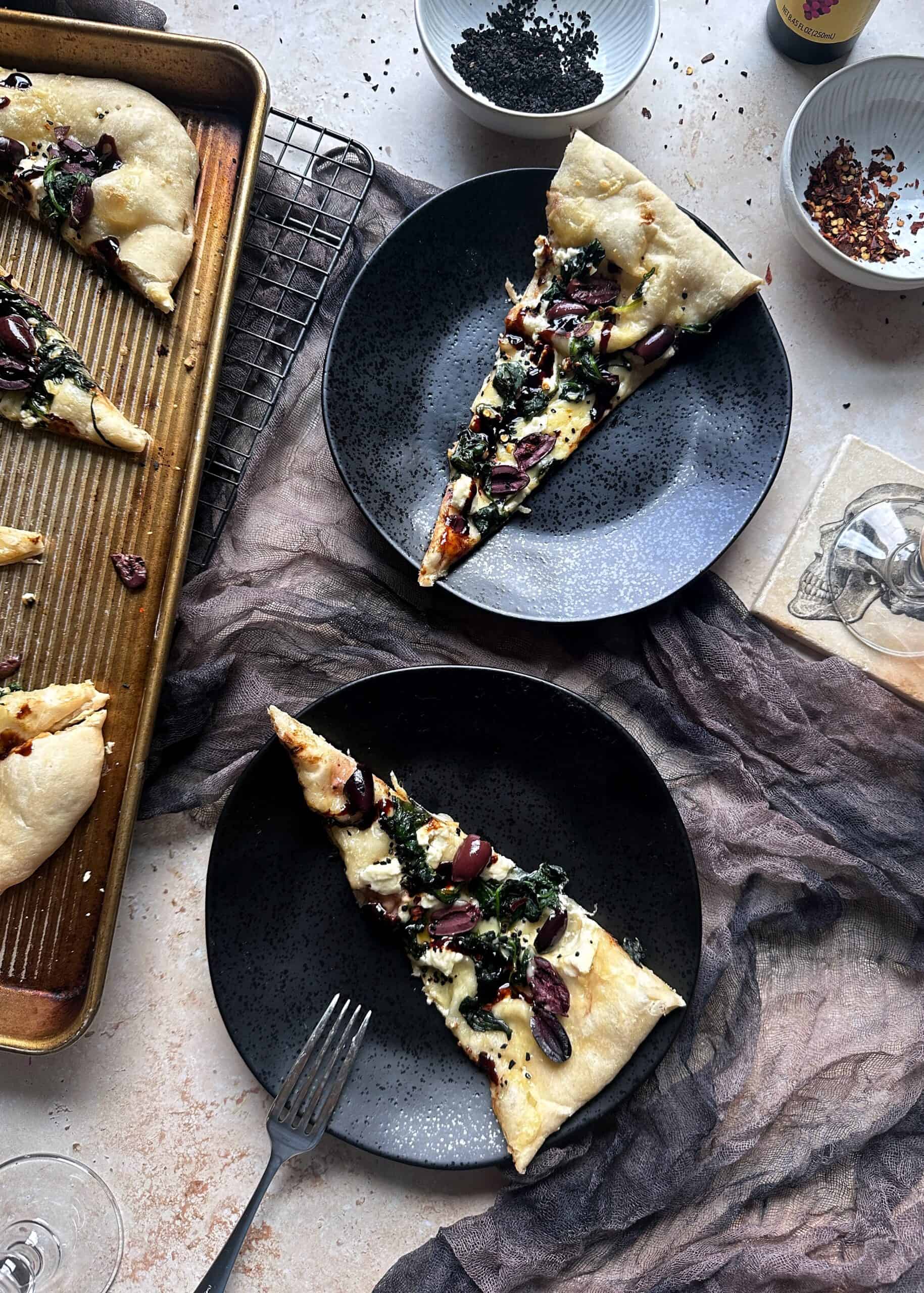 slices of black lagoon pizza on plates