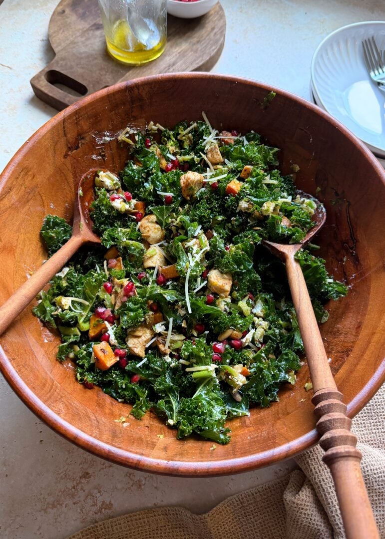 wooden bowl of roast chicken sprouts sweet potato and kale salad