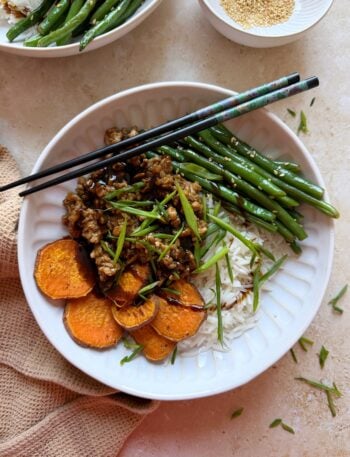bowl of hoisin chicken stir fry with sesame green beans and roasted sweet potatoes