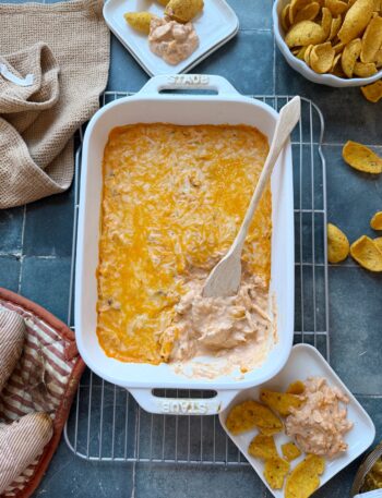 casserole dish of high protein buffalo chicken dip with chips on the side