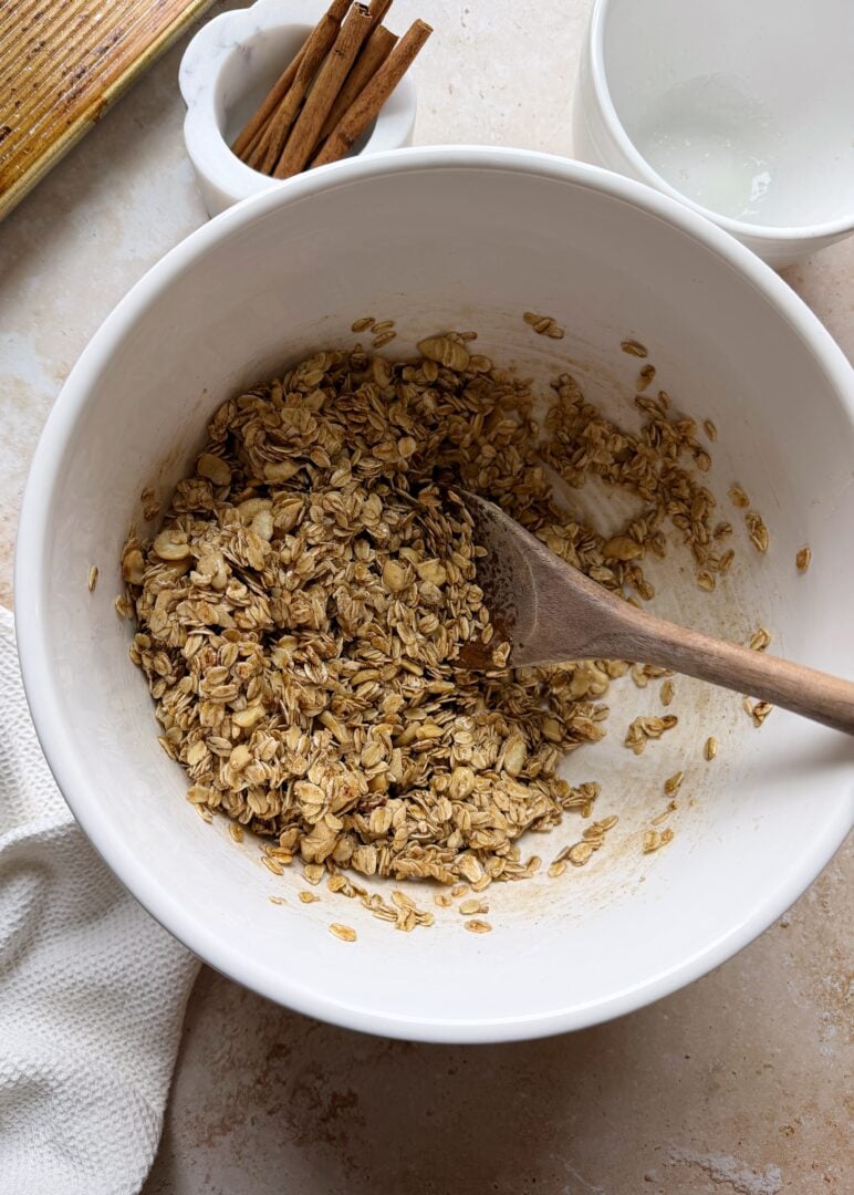 cinnamon granola in a mixing bowl before baking