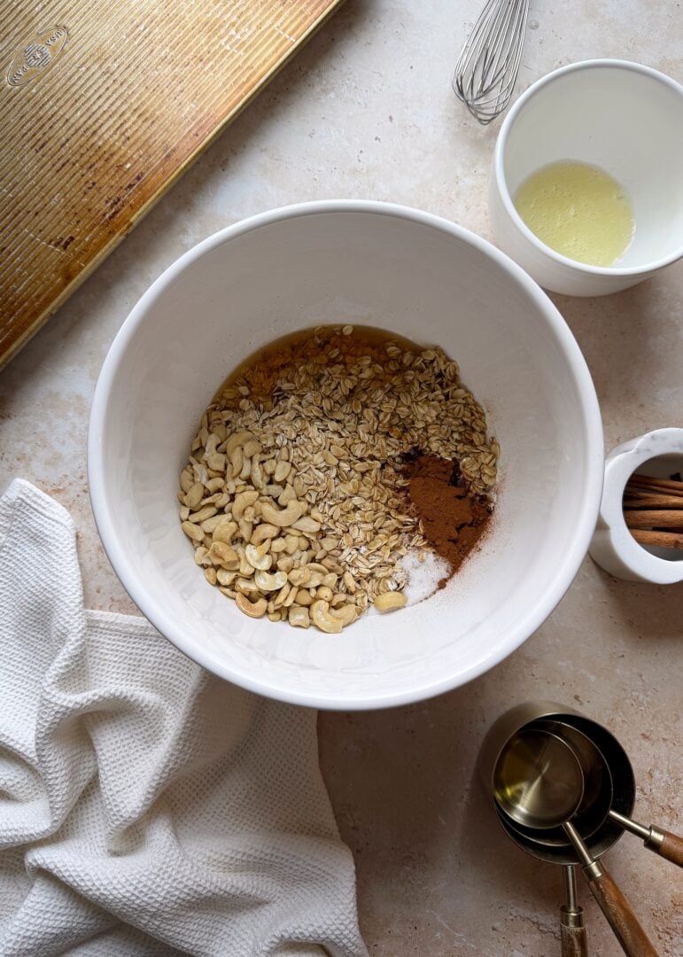 crunchy cinnamon granola ingredients in a mixing bowl