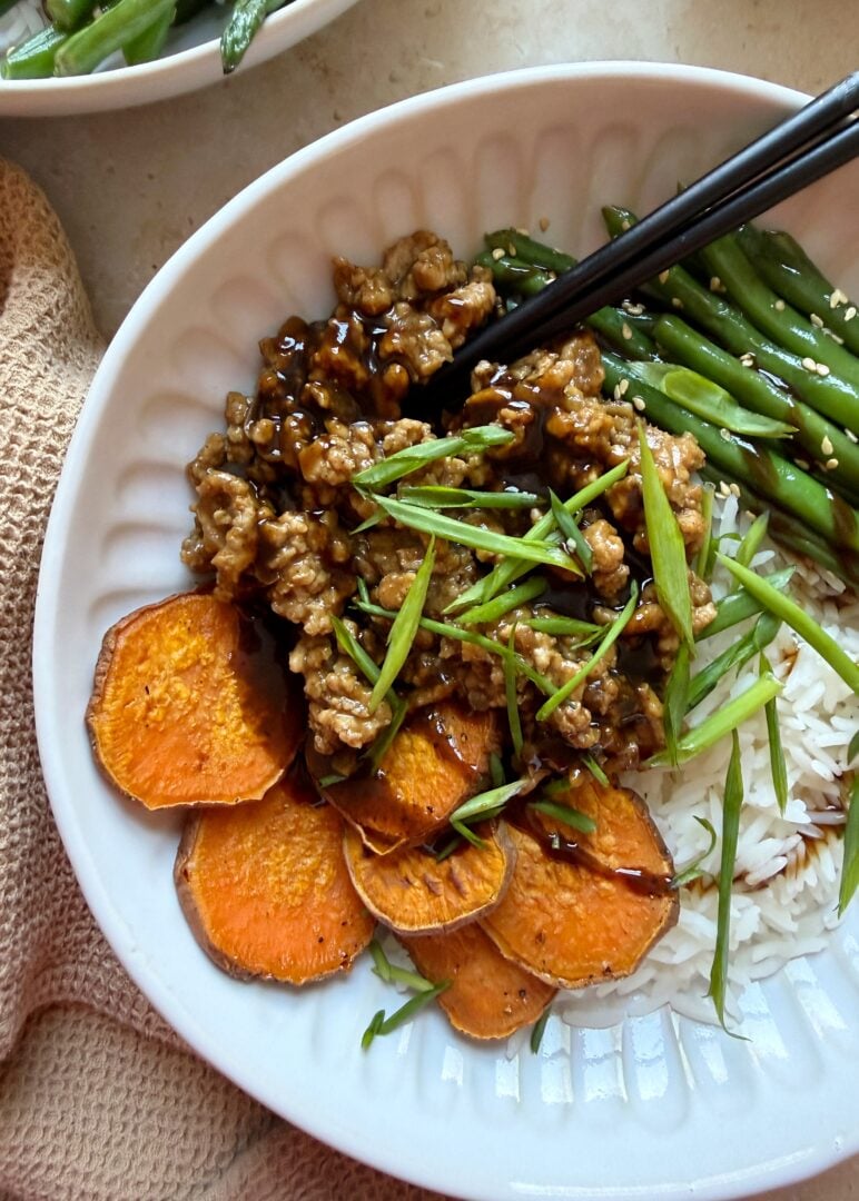 hoisin chicken stir fry with sesame green beans and roasted sweet potatoes with chopsticks