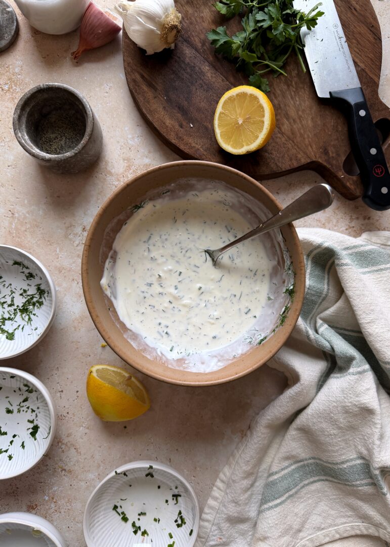 mixing herby buttermilk ranch dressing in a bowl